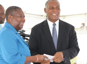 Dr. Robertine Chaderton, Chairperson of the Sugar Industry Diversification Fund Board of Counsellors hands over the third instalment of a $9million commitment to Premier of Nevis and Minister of Finance Hon. Vance Amory at the ground breaking ceremony on May 31, 2017, for construction of the $18million Alexandra Hospital Expansion Project